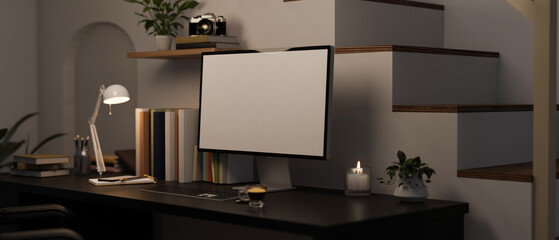 Modern home working space at night with computer mockup on black table near the stairs.