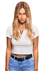 Fototapeta premium Beautiful blonde young woman wearing casual white tshirt skeptic and nervous, frowning upset because of problem. negative person.