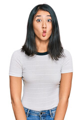 Fototapeta premium Beautiful asian young woman wearing casual white t shirt making fish face with lips, crazy and comical gesture. funny expression.