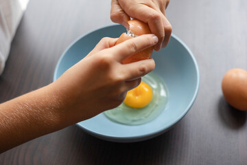 Fototapeta na wymiar egg yolk in blue bowl close up
