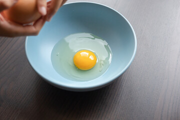 egg yolk in blue bowl close up