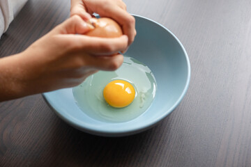egg yolk in blue bowl close up