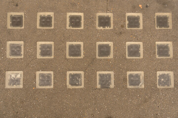 Closeup geometrically laid glass blocks sidewalk background