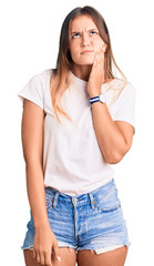 Obraz premium Beautiful caucasian woman wearing casual white tshirt touching mouth with hand with painful expression because of toothache or dental illness on teeth. dentist