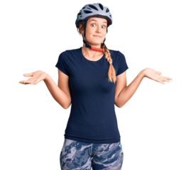Beautiful caucasian woman wearing bike helmet clueless and confused expression with arms and hands raised. doubt concept.
