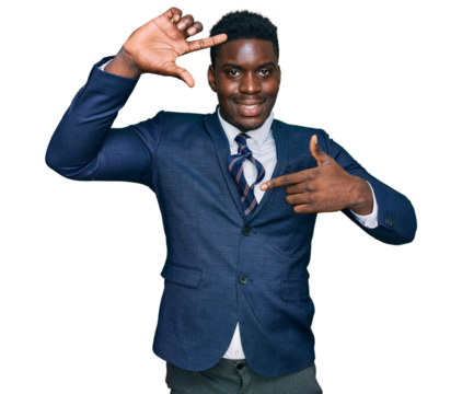 Handsome business black man wearing business suit and tie smiling making frame with hands and fingers with happy face. creativity and photography concept.