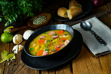 Hearty rustic pea soup with bacon and sausage
