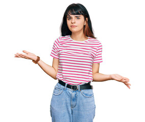 Young hispanic girl wearing casual clothes clueless and confused with open arms, no idea concept.