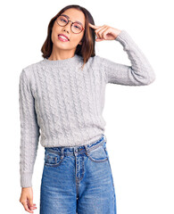 Fototapeta premium Young beautiful chinese girl wearing casual clothes smiling pointing to head with one finger, great idea or thought, good memory