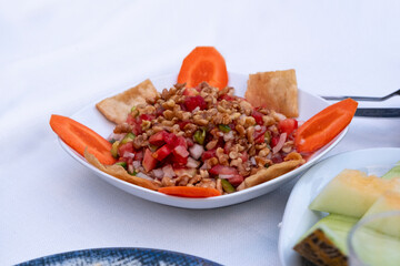 Turkish traditional appetizer known as gavurdagi salad with walnut tomato onion and carrot, Terkey food concept, selective focus, appetizer idea