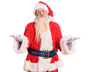 Old senior man with grey hair and long beard wearing traditional santa claus costume smiling cheerful offering hands giving assistance and acceptance.
