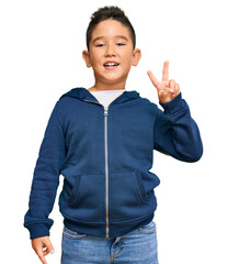 Little boy hispanic kid wearing casual sporty jacket smiling with happy face winking at the camera...