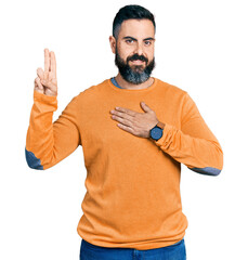 Hispanic man with beard wearing casual winter sweater smiling swearing with hand on chest and...