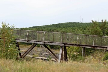 Fototapeta na wymiar unusual old wooden bridge for the passage of people