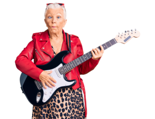 Senior beautiful woman with blue eyes and grey hair wearing a modern look playing electric guitar making fish face with lips, crazy and comical gesture. funny expression.