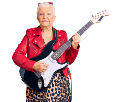 Senior beautiful woman with blue eyes and grey hair wearing a modern look playing electric guitar relaxed with serious expression on face. simple and natural looking at the camera.