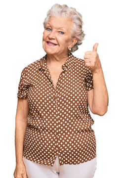 Senior grey-haired woman wearing casual clothes smiling happy and positive, thumb up doing excellent and approval sign