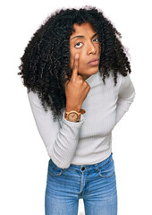 Young african american girl wearing casual clothes pointing to the eye watching you gesture, suspicious expression - obrazy, fototapety, plakaty