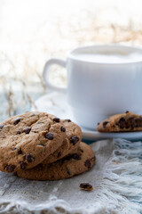 Chocolate chip cookies and a cup of latte on a blue wooden table