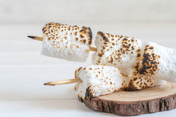 Roasted marshmallow on wooden background for Jewish holiday Lag BaOmer, for American Independence...