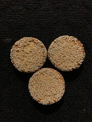 biscuits with sesame sprinkles isolated on a dark background