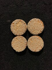 biscuits with sesame sprinkles isolated on a dark background