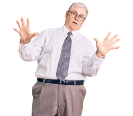 Senior grey-haired man wearing business clothes afraid and terrified with fear expression stop gesture with hands, shouting in shock. panic concept.