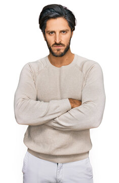 Young hispanic man wearing casual clothes skeptic and nervous, disapproving expression on face with crossed arms. negative person.