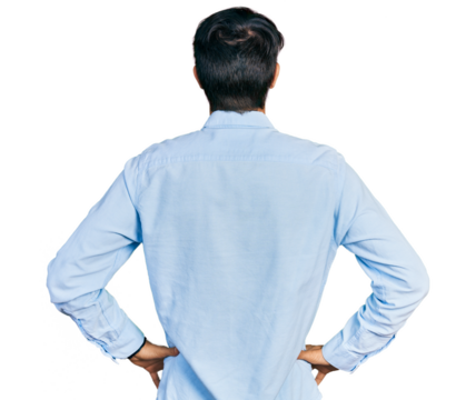 Hispanic man with blue eyes wearing business shirt standing backwards looking away with arms on body