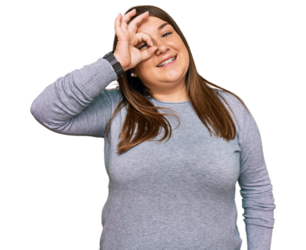 Beautiful brunette plus size woman wearing casual clothes doing ok gesture with hand smiling, eye looking through fingers with happy face.