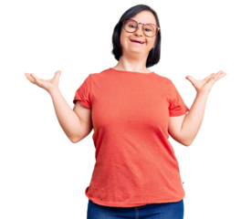 Brunette woman with down syndrome wearing casual clothes and glasses celebrating victory with happy smile and winner expression with raised hands