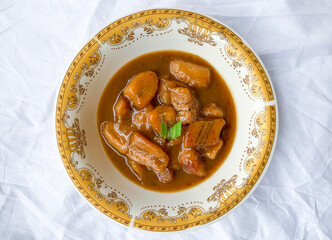 Traditional snack from Indonesia called Kolak Pisang, made from banana with coconut milk sauce and palm sugar.