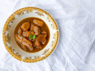 Traditional snack from Indonesia called Kolak Pisang, made from banana with coconut milk sauce and palm sugar.