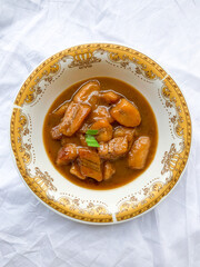 Traditional snack from Indonesia called Kolak Pisang, made from banana with coconut milk sauce and palm sugar.