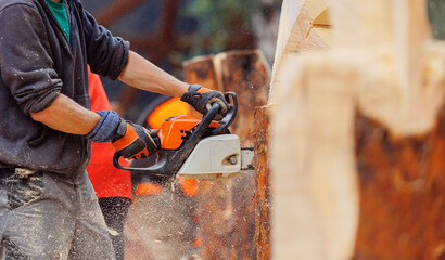 Professional Woodcutter saws cut tree with chainsaw on sawmill. Concept industry timber