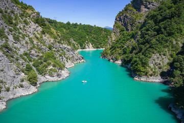 The lake Monteynard, the Panaroma from Himalayan Bridge, France , Isère. Little boat alone with...
