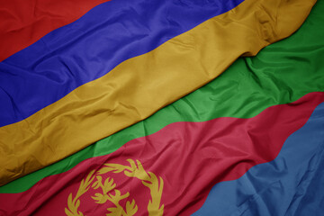 waving colorful flag of eritrea and national flag of armenia.