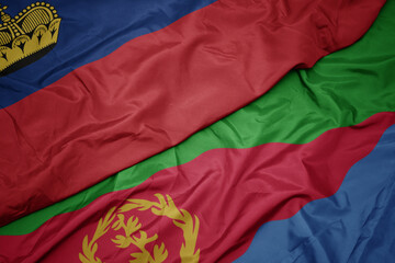 waving colorful flag of eritrea and national flag of liechtenstein.