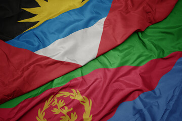 waving colorful flag of eritrea and national flag of antigua and barbuda.