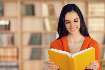 Pensive woman book lover spending free leisure time in library,