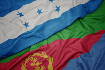 waving colorful flag of eritrea and national flag of honduras.