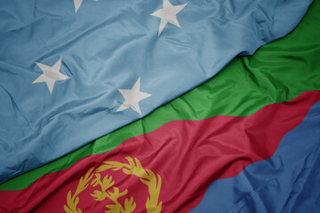 waving colorful flag of eritrea and national flag of Federated States of Micronesia .