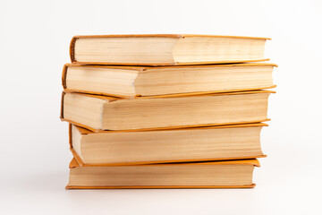 Stack of old books on light background. Book pile.