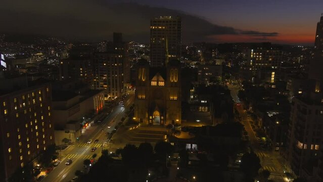 Grace Cathedral in San Francisco, California and the surrounding community at dusk - aerial view