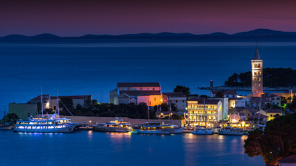 Fototapeta na wymiar the port of novalja in croatia photographed at night in the form of a long exposure with lights taken in summer