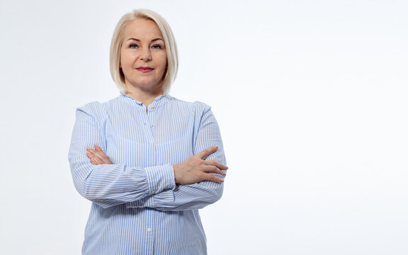 Serious business woman with folded arms on white background