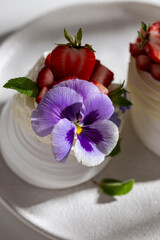 Meringue caked with pansies on a plate