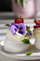Meringue caked with pansies on a plate