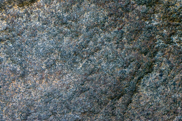 Raw granite rock texture background. Fragment of natural stone wall.