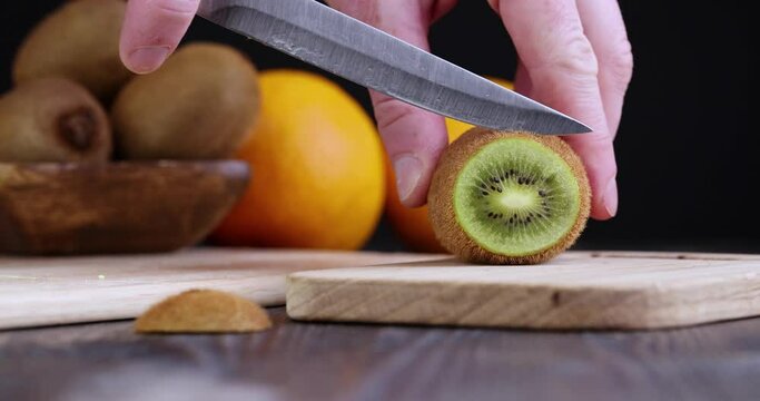 cutting kiwi fruit on the kitchen table, ripe kiwi fruit for nutrition during cooking